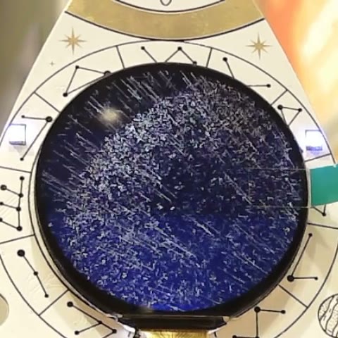 Thousands of particle streaks scattering across the dark badge display.