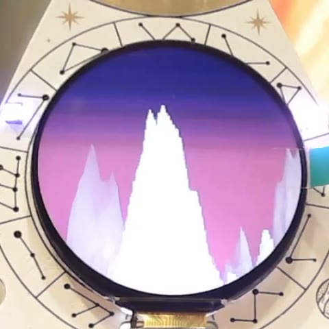 White mountain ridges against a violet dawn sky on the badge display.