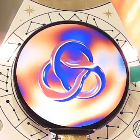 The chrome torus knot over orange and blue plasma on the badge's round display.